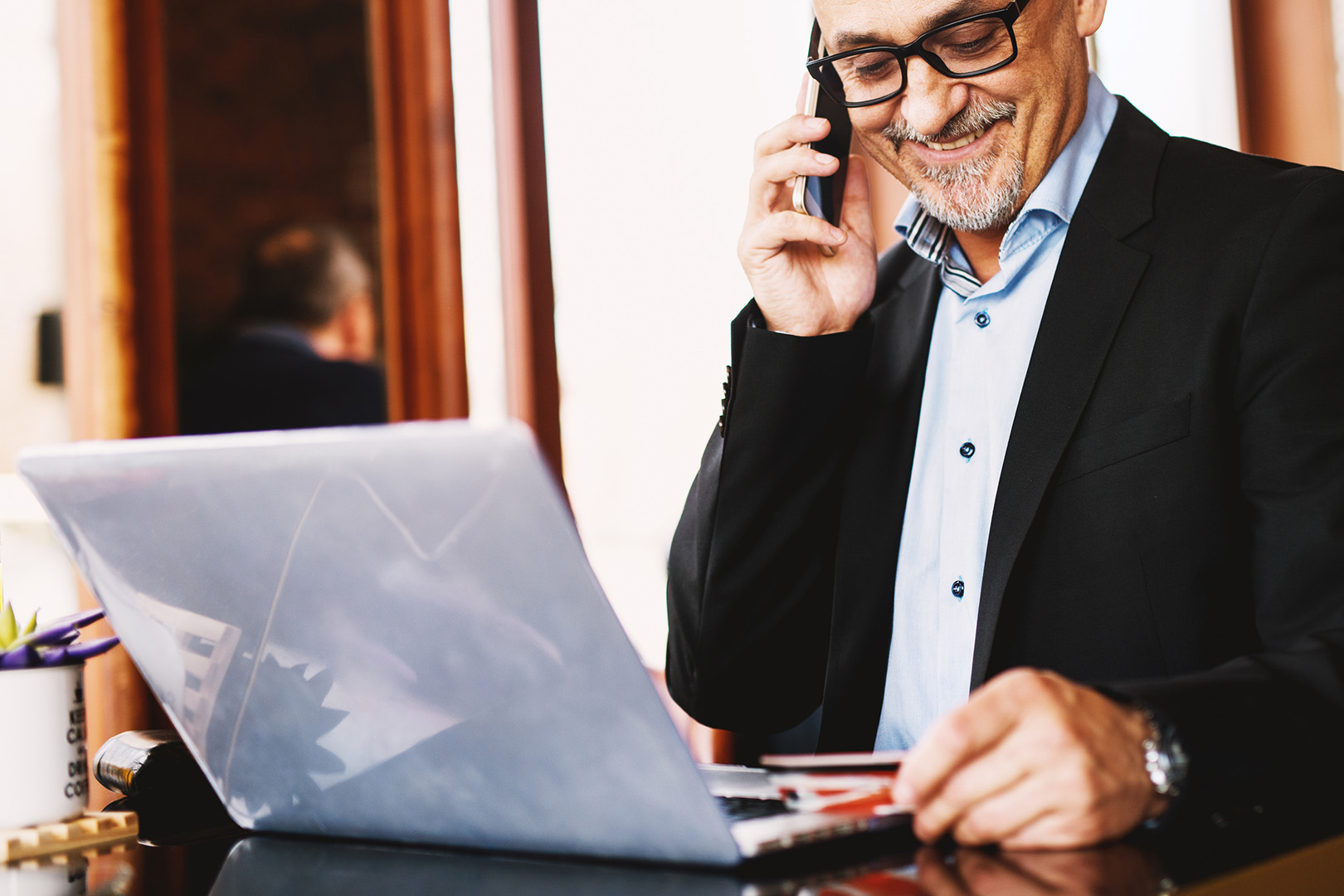 business man smiling while on phone